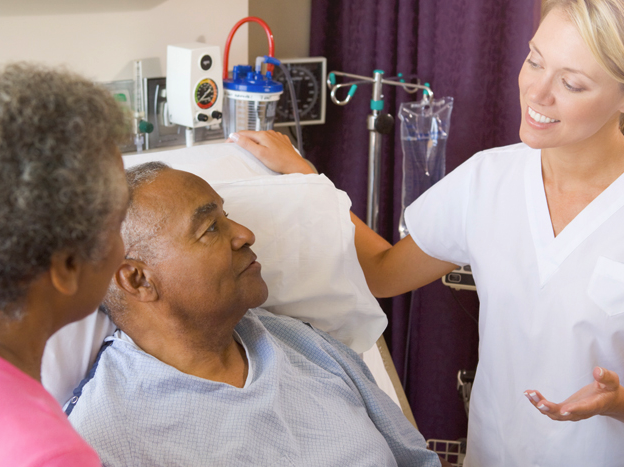 Doctor speaking to patient and his wife