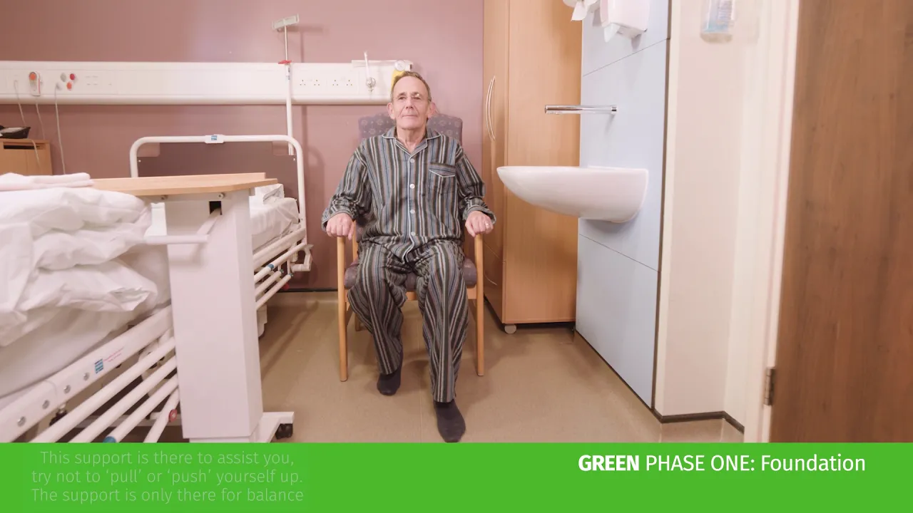 a man sitting in a chair in a hospital room